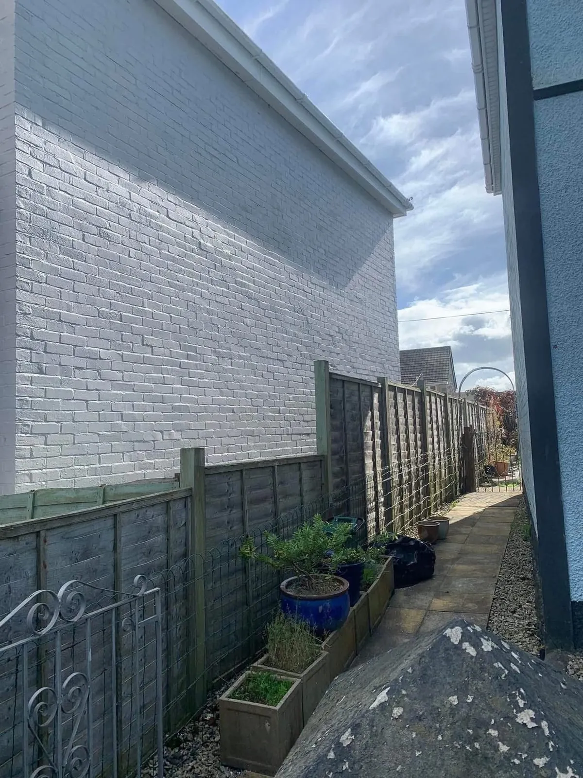 Freshly painted brick wall after preparation and masonry paint in St Just